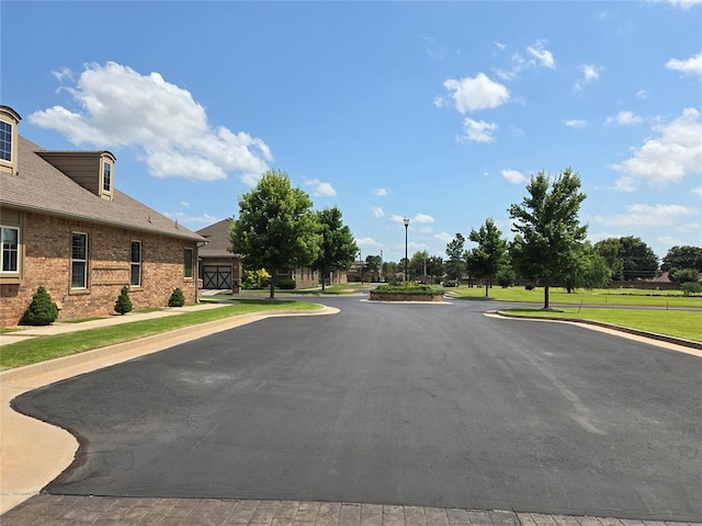 9252 Elaine Dr, Midwest City, OK 73130 - view of asphalt street featuring street lighting, curbs, and sidewalks