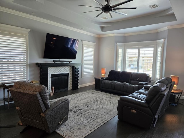 9252 Elaine Dr, Midwest City, OK 73130 - living room with a tray ceiling, ceiling fan, wood finished floors, a fireplace, and ornamental molding