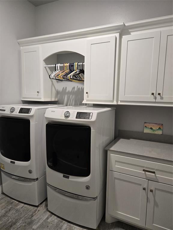 9252 Elaine Dr, Midwest City, OK 73130 - washroom with cabinet space, independent washer and dryer, and wood finished floors