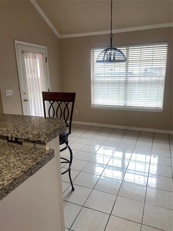 5725 SE 86th St, Oklahoma City, OK 73135 - dining area featuring light tile patterned flooring, lofted ceiling, and ornamental molding