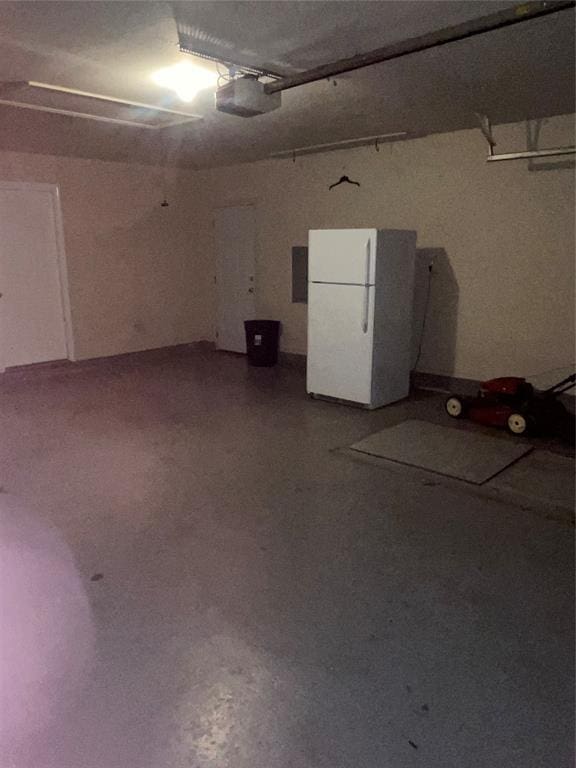 5725 SE 86th St, Oklahoma City, OK 73135 - garage with freestanding refrigerator and a garage door opener