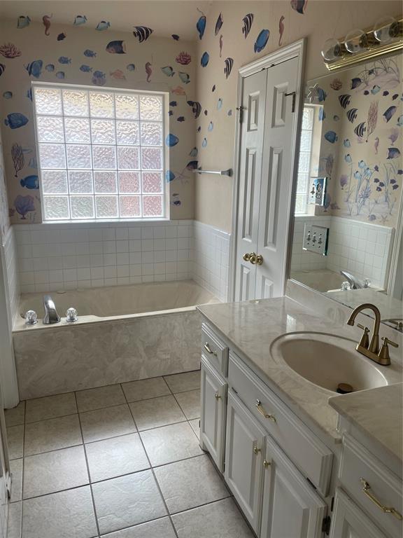 5725 SE 86th St, Oklahoma City, OK 73135 - bathroom featuring healthy amount of natural light, a bath, vanity, tile patterned floors, and wallpapered walls