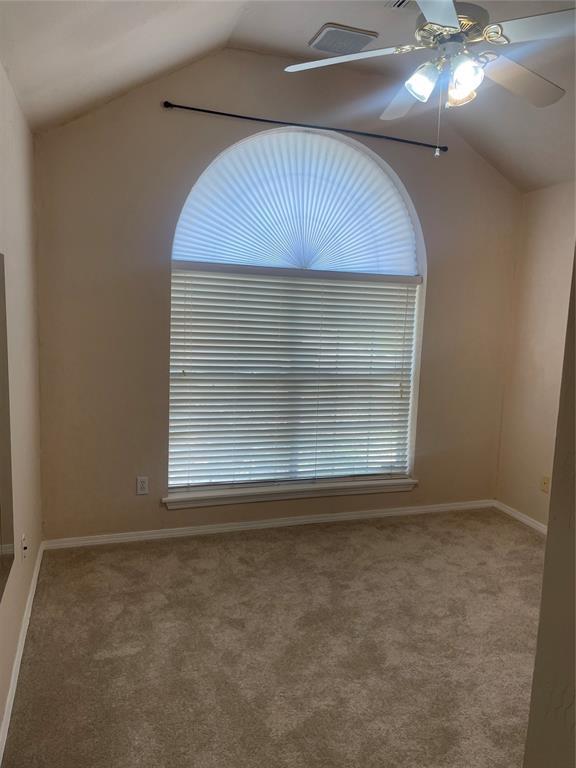 5725 SE 86th St, Oklahoma City, OK 73135 - carpeted empty room featuring lofted ceiling and a ceiling fan