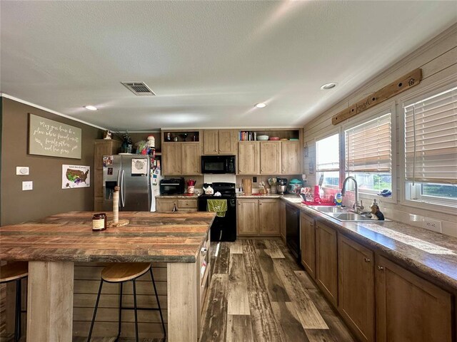 420 N College St, Cordell, OK 73632 - kitchen featuring black appliances, open shelves, dark wood-style floors, healthy amount of natural light, and crown molding