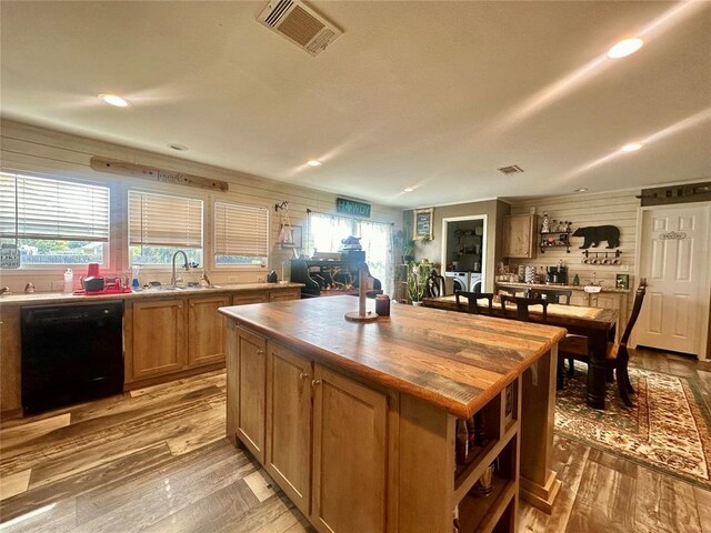 420 N College St, Cordell, OK 73632 - kitchen with dishwasher, independent washer and dryer, open shelves, butcher block counters, and light wood-style floors