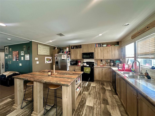 420 N College St, Cordell, OK 73632 - kitchen featuring black appliances, open shelves, wood finished floors, a breakfast bar area, and recessed lighting