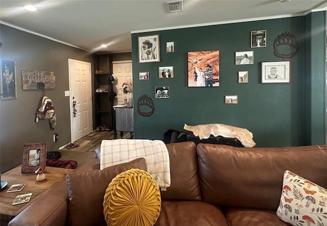 420 N College St, Cordell, OK 73632 - living room featuring ornamental molding, radiator heating unit, and wood finished floors