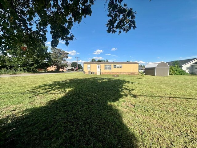 420 N College St, Cordell, OK 73632 - view of green lawn with a storage unit