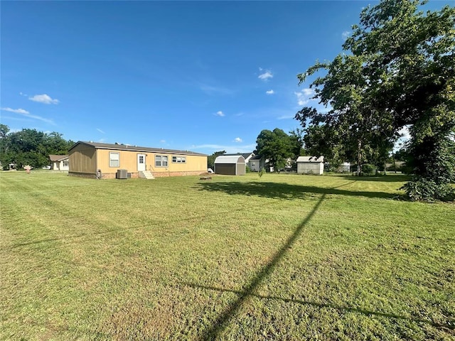 420 N College St, Cordell, OK 73632 - view of green lawn featuring a storage shed
