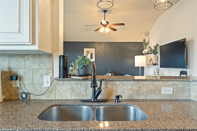 2548 NW 184th St, Edmond, OK 73012 - kitchen with ceiling fan, stone counters, and decorative backsplash