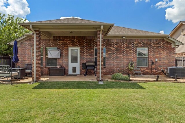 2548 NW 184th St, Edmond, OK 73012 - rear view of property featuring a patio, brick siding, and roof with shingles