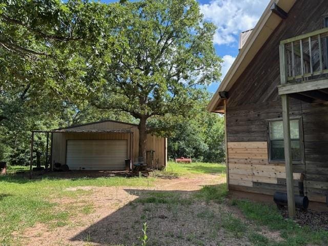 11825 N 3660th Rd, Cromwell, OK 74884 - view of yard featuring a detached garage, an outbuilding, and dirt driveway
