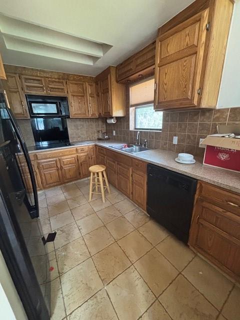11825 N 3660th Rd, Cromwell, OK 74884 - kitchen with black appliances, tasteful backsplash, brown cabinets, light countertops, and light tile patterned floors