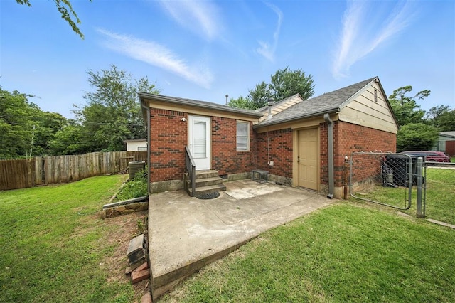 3534 Garden Pl, Oklahoma City, OK 73112 - rear view of property featuring entry steps, brick siding, a patio, and roof with shingles