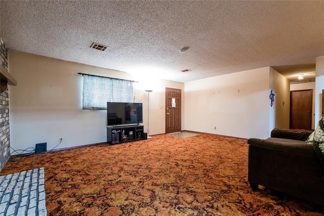 1319 N Cook, Cordell, OK 73632 - carpeted living room featuring a fireplace and a textured ceiling