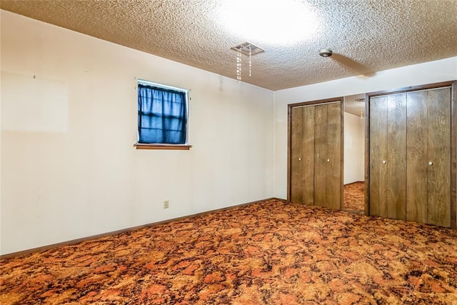 1319 N Cook, Cordell, OK 73632 - unfurnished bedroom with carpet, multiple closets, and a textured ceiling