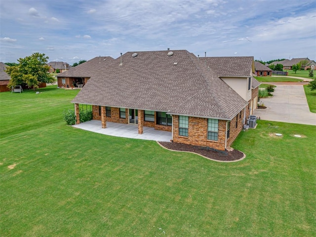 3004 Twin Lake Dr, Moore, OK 73165 - rear view of property featuring a yard, stone siding, and roof with shingles