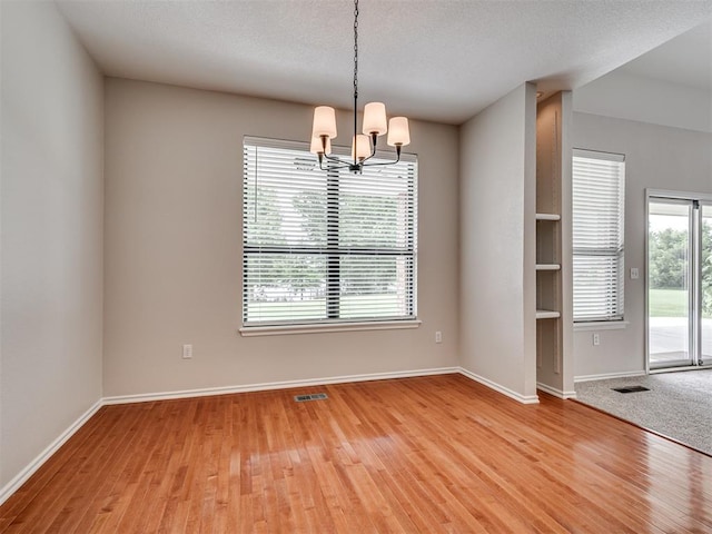3004 Twin Lake Dr, Moore, OK 73165 - spare room featuring a chandelier and light wood finished floors