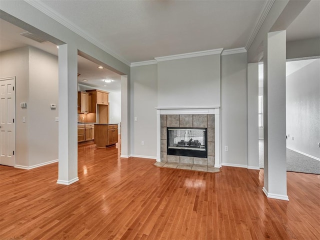 3004 Twin Lake Dr, Moore, OK 73165 - unfurnished living room featuring light wood-style floors, crown molding, and a fireplace