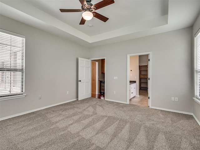 3004 Twin Lake Dr, Moore, OK 73165 - unfurnished bedroom with a spacious closet, light colored carpet, and a raised ceiling