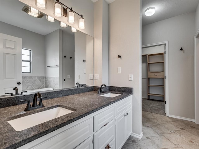 3004 Twin Lake Dr, Moore, OK 73165 - full bath featuring double vanity, a tub, and a spacious closet