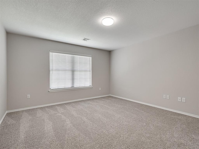 3004 Twin Lake Dr, Moore, OK 73165 - empty room with carpet flooring and a textured ceiling