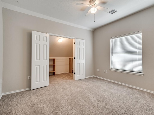 3004 Twin Lake Dr, Moore, OK 73165 - unfurnished bedroom featuring a walk in closet, carpet floors, a closet, and ceiling fan