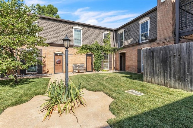 6100 N Brookline Ave Unit 2, Oklahoma City, OK 73112 - back of house with brick siding, roof with shingles, and mansard roof