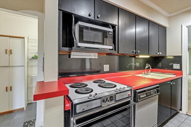 6100 N Brookline Ave Unit 2, Oklahoma City, OK 73112 - kitchen with electric range oven, ornamental molding, tasteful backsplash, and dark cabinetry
