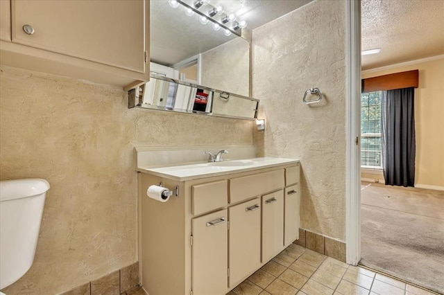 6100 N Brookline Ave Unit 2, Oklahoma City, OK 73112 - bathroom with a textured wall, vanity, tile patterned flooring, and a textured ceiling