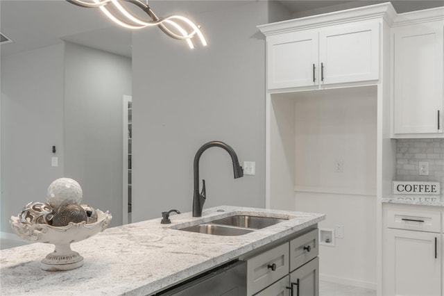 219 SE 45th St, Oklahoma City, OK 73129 - kitchen with backsplash, light stone countertops, and white cabinetry