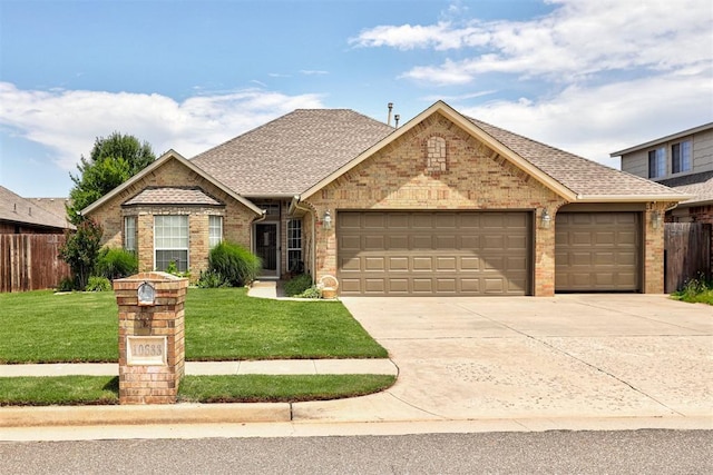 10633 NW 38th St, Yukon, OK 73099 - view of front of property with an attached garage, concrete driveway, brick siding, and roof with shingles