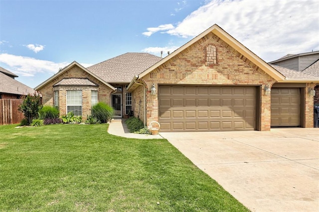 10633 NW 38th St, Yukon, OK 73099 - view of front of property featuring an attached garage, concrete driveway, brick siding, and roof with shingles