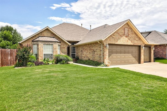 10633 NW 38th St, Yukon, OK 73099 - view of front of property featuring an attached garage, a shingled roof, driveway, and brick siding