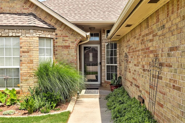 10633 NW 38th St, Yukon, OK 73099 - doorway to property with a shingled roof and brick siding