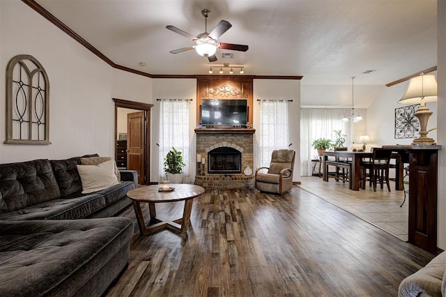 10633 NW 38th St, Yukon, OK 73099 - living area featuring a ceiling fan, healthy amount of natural light, dark wood-style floors, and crown molding