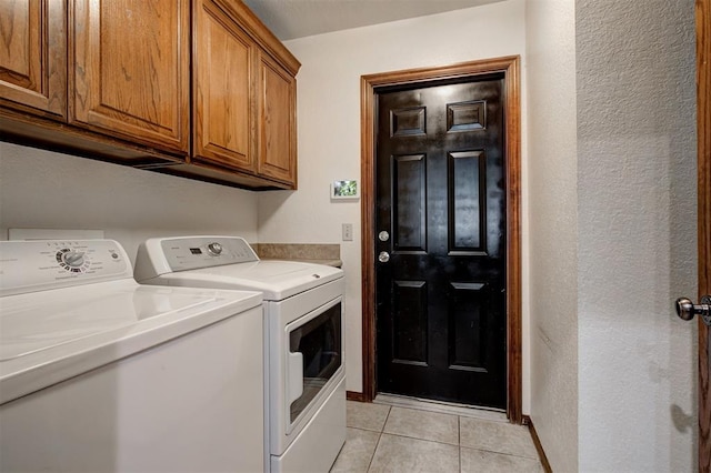 10633 NW 38th St, Yukon, OK 73099 - washroom featuring independent washer and dryer, cabinet space, light tile patterned floors, and a textured wall