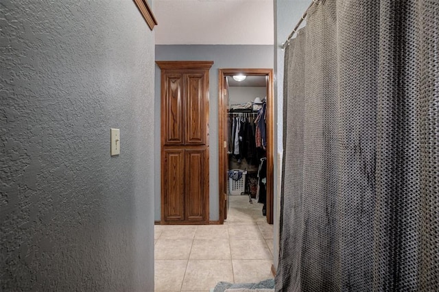 10633 NW 38th St, Yukon, OK 73099 - corridor featuring a textured wall and light tile patterned floors