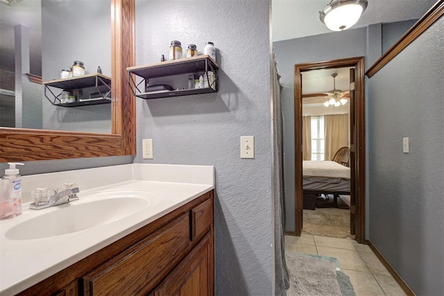 10633 NW 38th St, Yukon, OK 73099 - bathroom with a textured wall, vanity, tile patterned floors, and ensuite bathroom