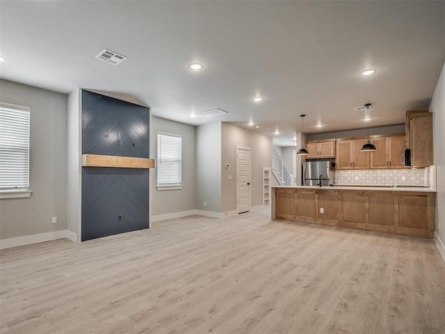 609 W 2nd St, Edmond, OK 73003 - kitchen with freestanding refrigerator, light wood-style flooring, decorative backsplash, recessed lighting, and open floor plan