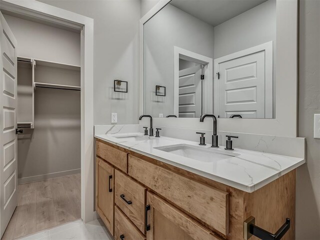 609 W 2nd St, Edmond, OK 73003 - bathroom with double vanity and a walk in closet