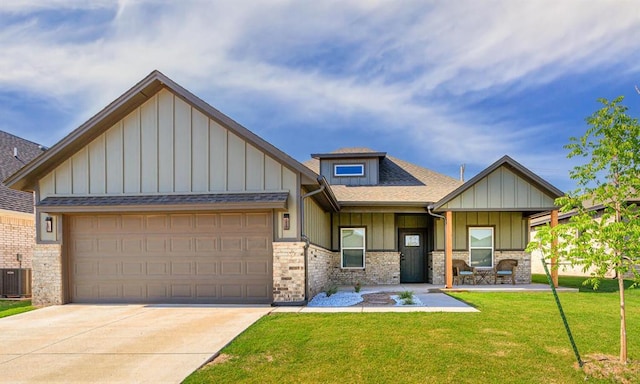 9228 NW 144th Pl, Yukon, OK 73099 - craftsman-style home with board and batten siding, a front lawn, concrete driveway, and an attached garage