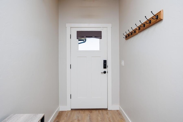 9228 NW 144th Pl, Yukon, OK 73099 - doorway to outside featuring light wood-style flooring and baseboards