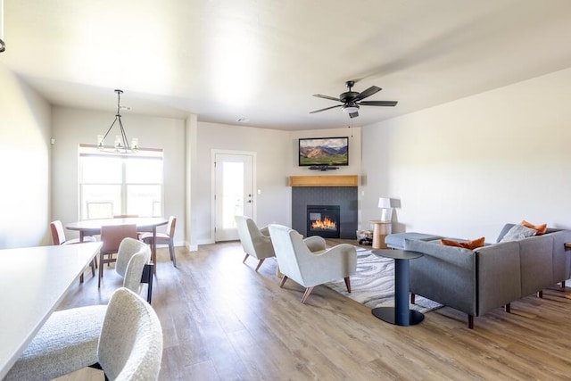9228 NW 144th Pl, Yukon, OK 73099 - living area with a glass covered fireplace, wood finished floors, and a ceiling fan