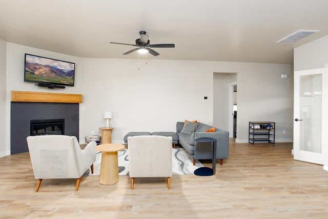 9228 NW 144th Pl, Yukon, OK 73099 - living area featuring wood finished floors, ceiling fan, and a brick fireplace