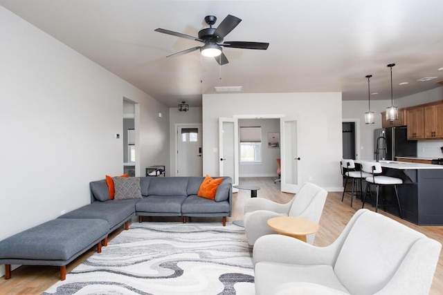 9228 NW 144th Pl, Yukon, OK 73099 - living room with light wood finished floors and a ceiling fan