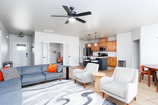 9228 NW 144th Pl, Yukon, OK 73099 - living room with light wood-style flooring and a ceiling fan
