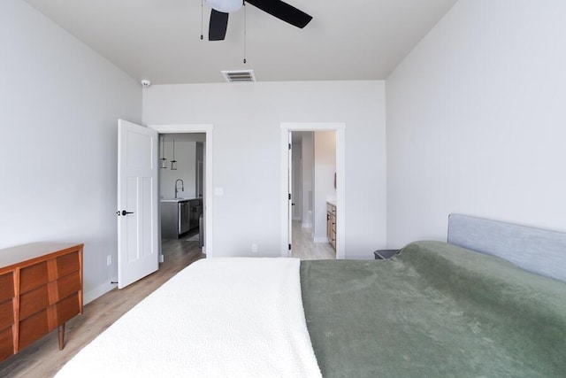 9228 NW 144th Pl, Yukon, OK 73099 - bedroom with light wood finished floors and ensuite bathroom