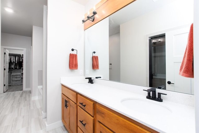 9228 NW 144th Pl, Yukon, OK 73099 - full bath with double vanity, a bathtub, and a walk in closet