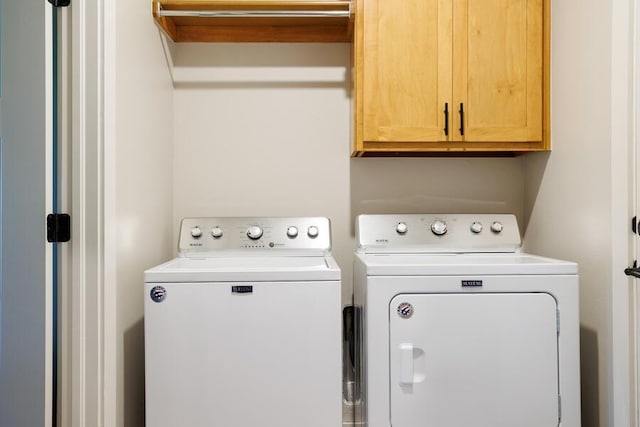 9228 NW 144th Pl, Yukon, OK 73099 - laundry room featuring washer and clothes dryer and cabinet space